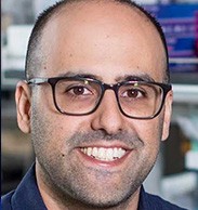 Tal Danino white man in early 30's with short black hair balding grinning