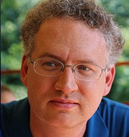 GAËL MCGILL white man curly light straw colored hair glasses looking whistfully