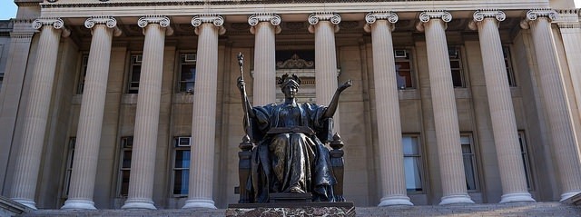 Image of Alma Mater Statue in front of the columns of Low Memorial